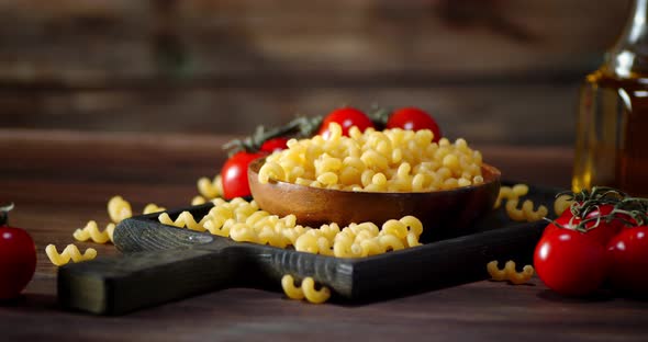 Pasta Dry Cavatappi on a Wooden Plate Slowly Rotates. 