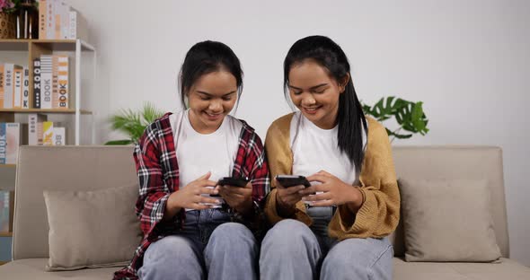 Asian twin girls watching smartphone
