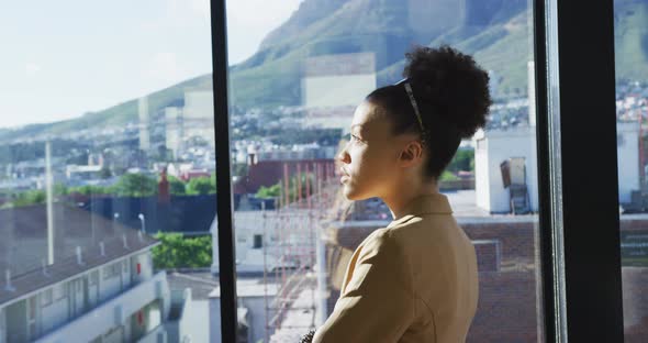 Young woman looking through the window