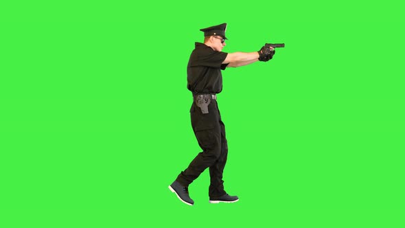 Caucasian Policeman Walks Gets the Gun Out Shoots and Reloads on a Green Screen Chroma Key