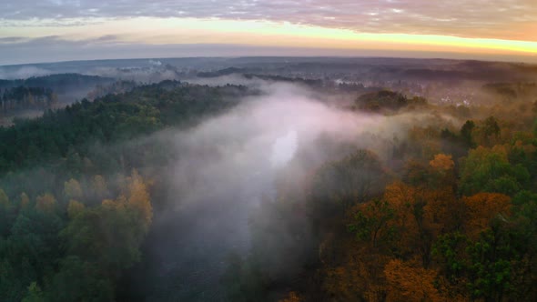 Foggy river and in autumn at sunrise, view from above