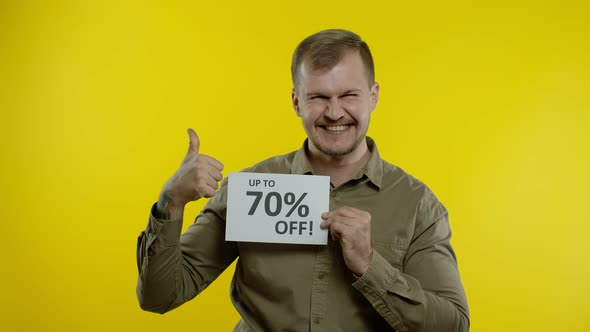 Attractive Man Showing Up To 70 Percent Off Inscriptions Signs, Rejoicing Good Discounts, Low Prices