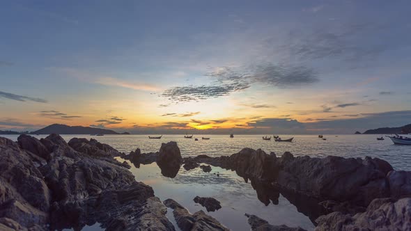 Time Lapse Scenery Sunset Above The Rock Beside The Beach.