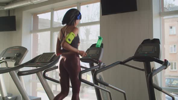 Adorable Fit Woman Running on Treadmill at Gym