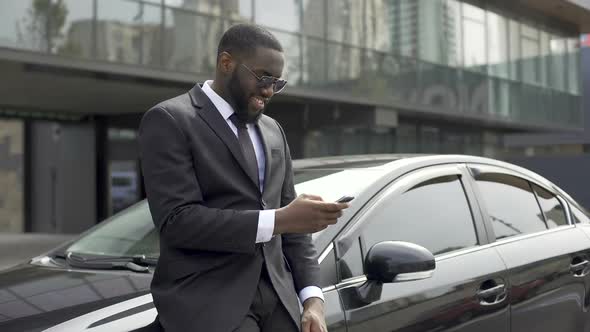 Masculine Man in Expensive Suit Waiting for Companion, Scrolling News on Gadget