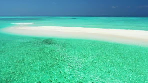 Aerial drone view seascape of relaxing seashore beach voyage by blue lagoon with white sand backgrou