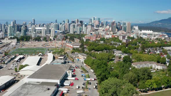 High Rise Buildings From The CBD And Vast Green Park In Strathcona Vancouver Canada - aerial shot