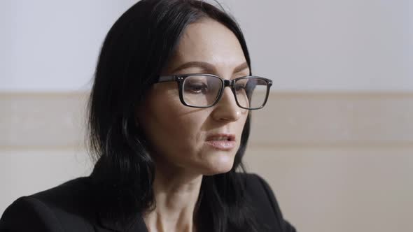 Headshot of Confident Beautiful Caucasian Woman in Eyeglasses Talking