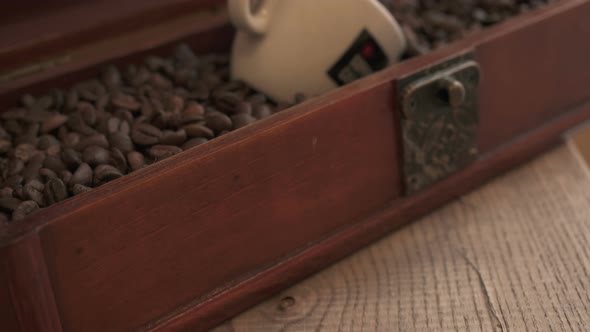 Coffee beans and coffee cup in drawer