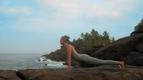 Woman in Grey Gets Into Adho Mukha Shvanasana Slow Motion