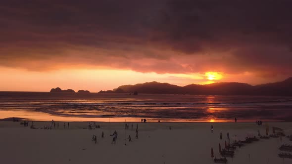 Aerial slow shot of a beautiful red sunset in the Red Island of Java.