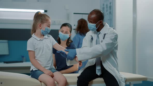 Medic Doing Palpation Consultation on Little Girl at Checkup Visit