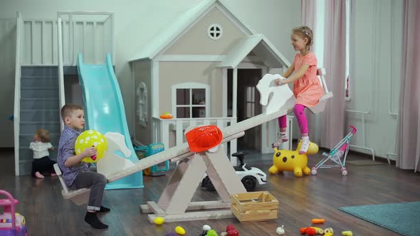 Preschoolers Riding Swing at Kindergarten