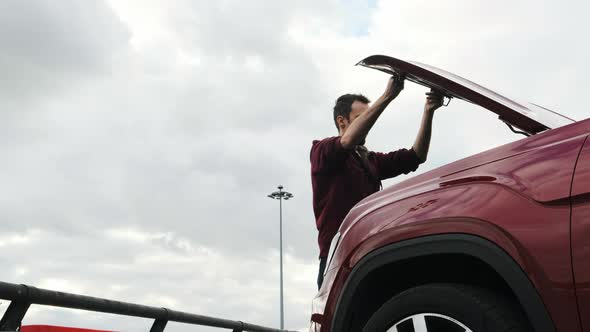 Man in a Red Overalls on the Street Arrived on Call From a Client, He Opens the Hood of Burgundy SUV