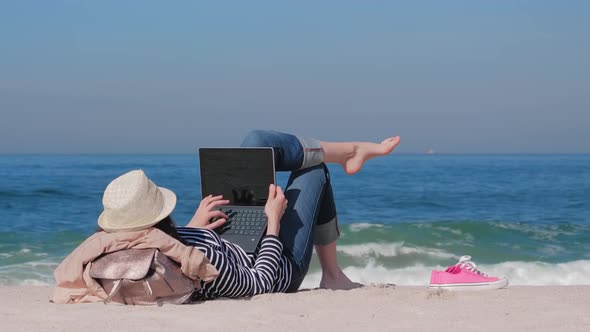 Woman Lying on Sand and Chatting Online on Beach Work Outside