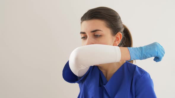 Doctor or Nurse Coughing Covering Mouth with Elbow