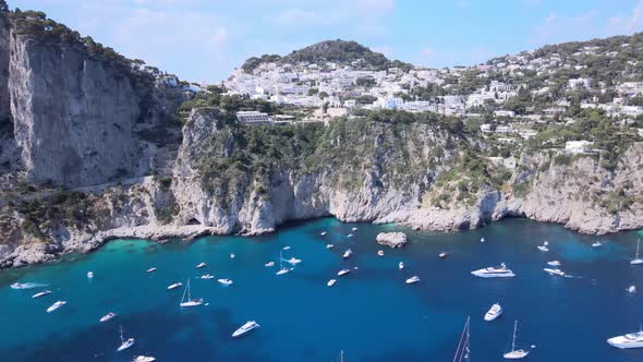 Aerial drone dolly shot of boats, yachts on the coastline of Capri,Italy.