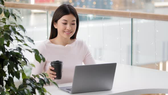 Asian Girl Student Distant Elearning Online Education in Cafe with Laptop Businesswoman Freelancer