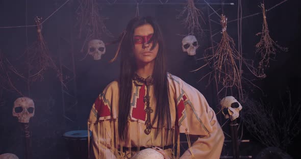 Native American Woman in Traditional Clothes Is Standing in the Smoke, 