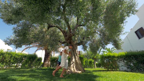 Joyful father and son playing tag in the garden