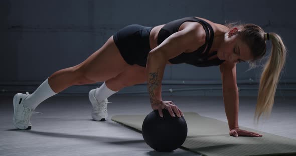 Muscular Woman Doing Pushups in the Gym