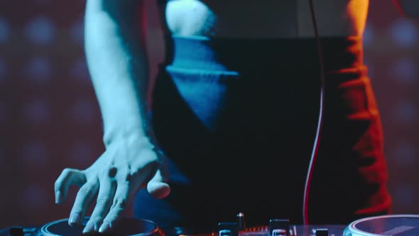 Female DJ Getting Ready to Play Set