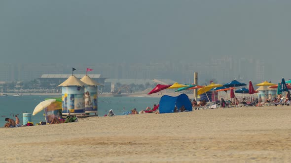 People on the Jumeirah Beach in Dubai UAE