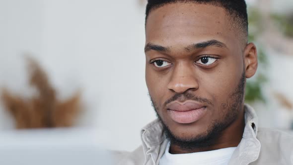 Portrait of African Business Man Freelancer Black Guy Afro Student Learns Language Looks Into Laptop