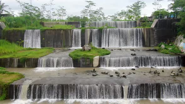 Aerial backwards view over Watu Purbo waterfall in Muntilan, Indonesia