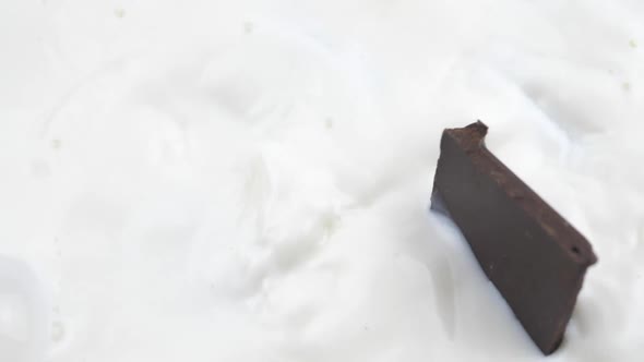 Chocolate Bars Falling in Milk Slow Motion