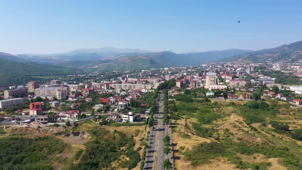  Aerial view highway between fields. Way to Stepanakert, capital of Artsakh, Caucasus.