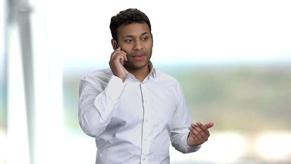 Businessman Talking on Transparent Futuristic Phone.