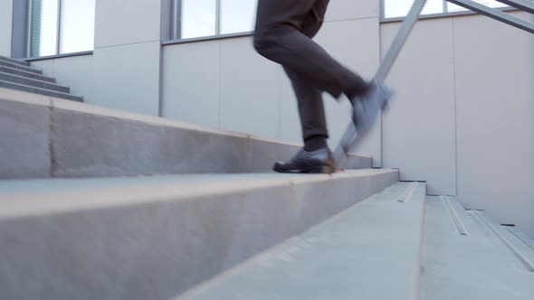 close up of business man steps up stairs. Male businessman walks up the stairs