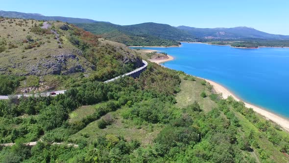 Aerial view of paved road passing artificial lake of Peruca, Croatia