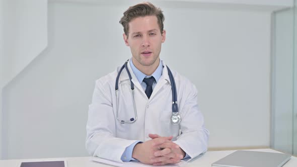 Professional Young Male Doctor Doing Consultation with Patient