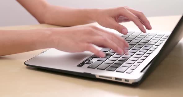 Typing on notebook computer at home