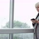 A Side View Slow Motion Close Up Video of a Middle-aged Female Executive Standing Near the Window of - VideoHive Item for Sale