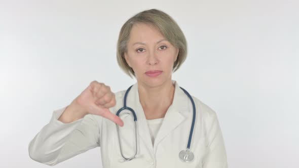 Thumbs Down By Old Female Doctor on White Background