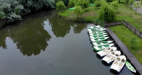 Small Boats In The Lake With Green Willow Trees In Summer