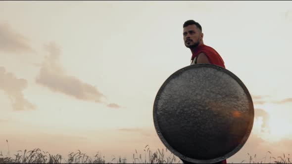 Spartan with Shield Walking in Dry Field.