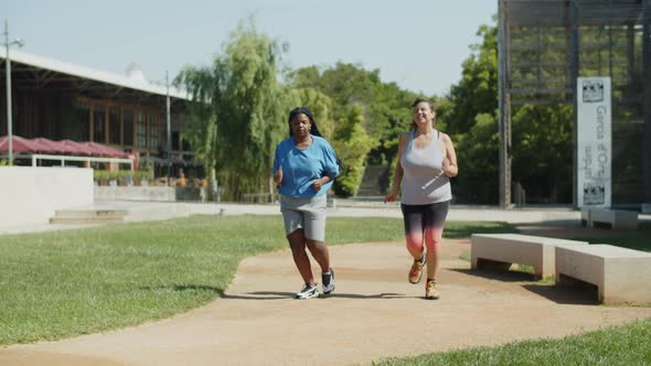 Long Shot of Overweight Women Coming to Tapes