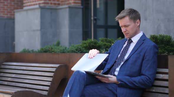 Businessman Coming and Sitting on Bench and working on Laptop