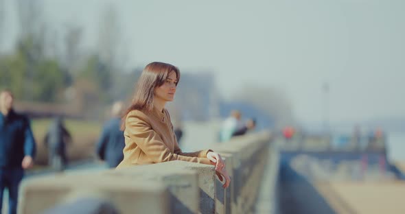 Nice Girl Stands at the Parapet of the Embankment and Looks Into the Distance