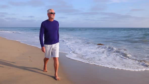 Mature Man Exercising At The Beach