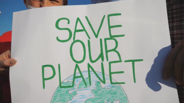 Close Up of Female and Male Hands of Young Couple Holding Placards of Movement for Saving Planet