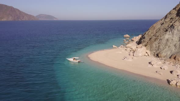 Beautiful Coastline Landscape with Rock and a Boat