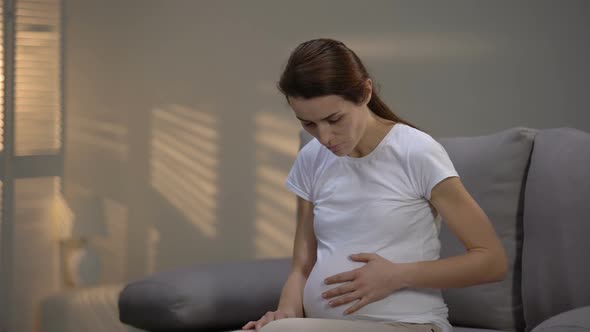 Hopeless Crying Pregnant Marital Mistreatment Victim Stroking Belly, Depression