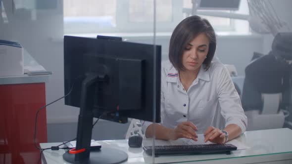 Woman Doctor in a Hospital Explorers of X-ray Images on the Monitor.