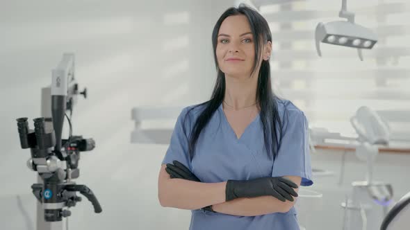 Young Female Dentist Standing In Office