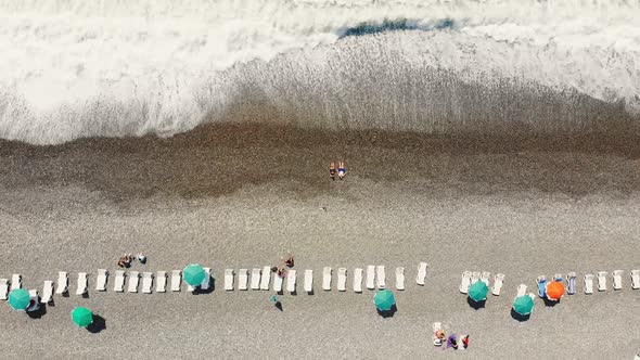 Top Down View Tourist Lay On Black Sea Beach